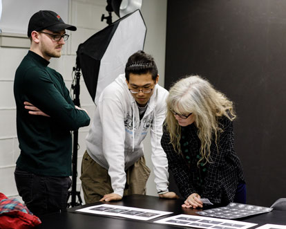 Cornell student works with faculty in class