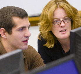 Professor Erin Davis working with a student in class
