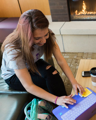 A Cornell College student researches financial aid on her computer.