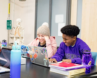 Cornell students in a biology classroom participate in a lab experiment.