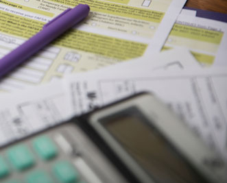 desk with FAFSA form and computer on it