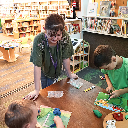 Cornell student at library internship as children's librarian
