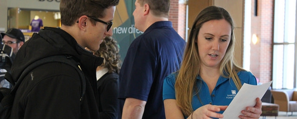 Cornell staff working with a student. 