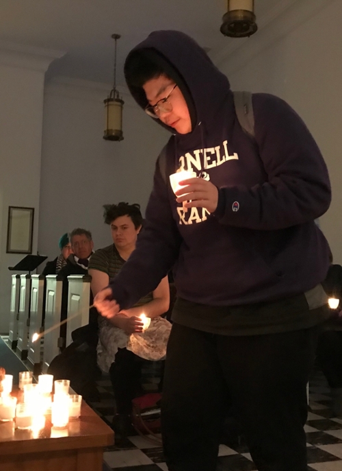 Student lights a candle