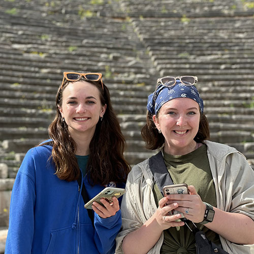 Students posing in front of historical site in Europe