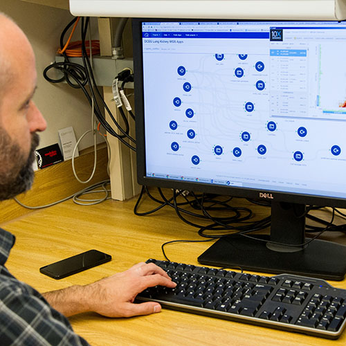 Analyst reviews cancer data trends. Photo credit National Cancer Institute