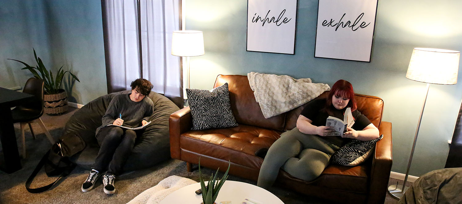 Students relaxing in the living room chill space