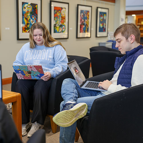 Students working together on laptops in Cole Library