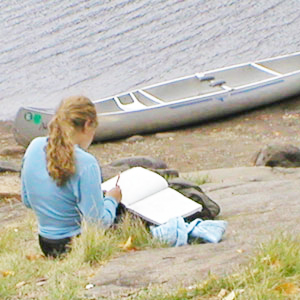 Student writing after canoe trip on the boundary waters