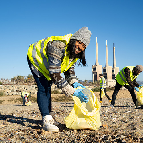 Volunteers on a beach picking up trash