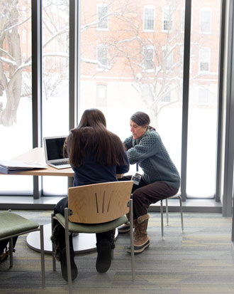 A Cornell College student works on a laptop