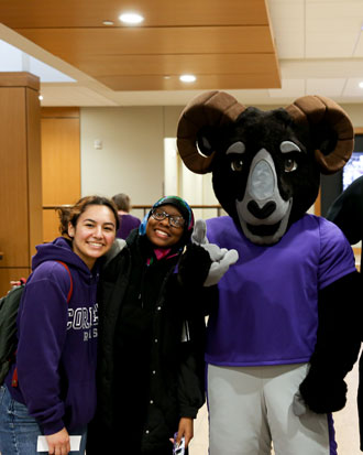 Cornell College student on campus with school mascot, Ulysses