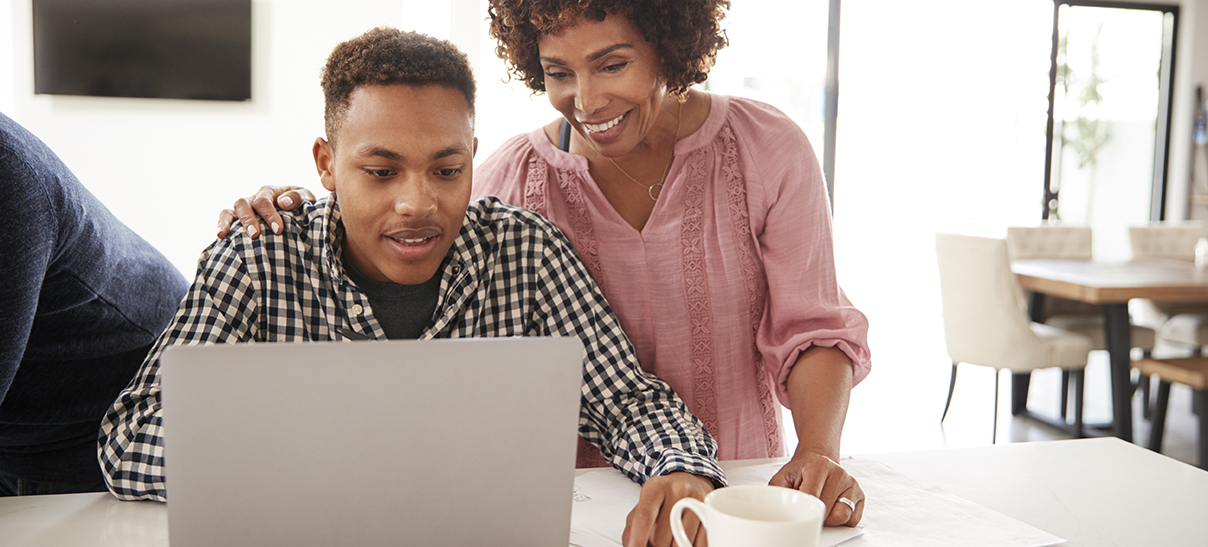Teen and parent working together on a laptop