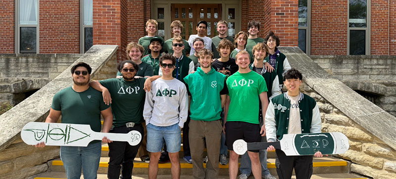 Members of the Delts gathered on staircase on campus