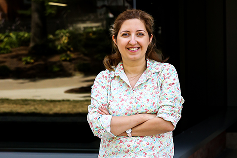 Niloofar Kamran standing with her arms crossed.