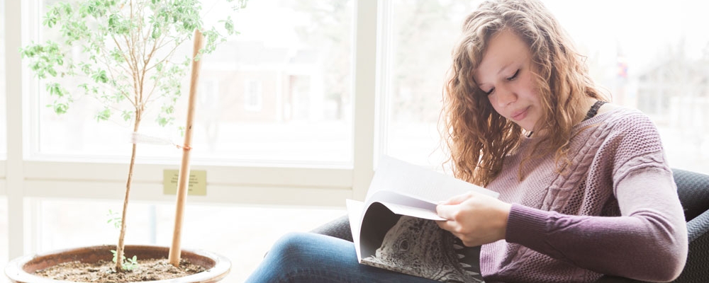 Student reads in the library.