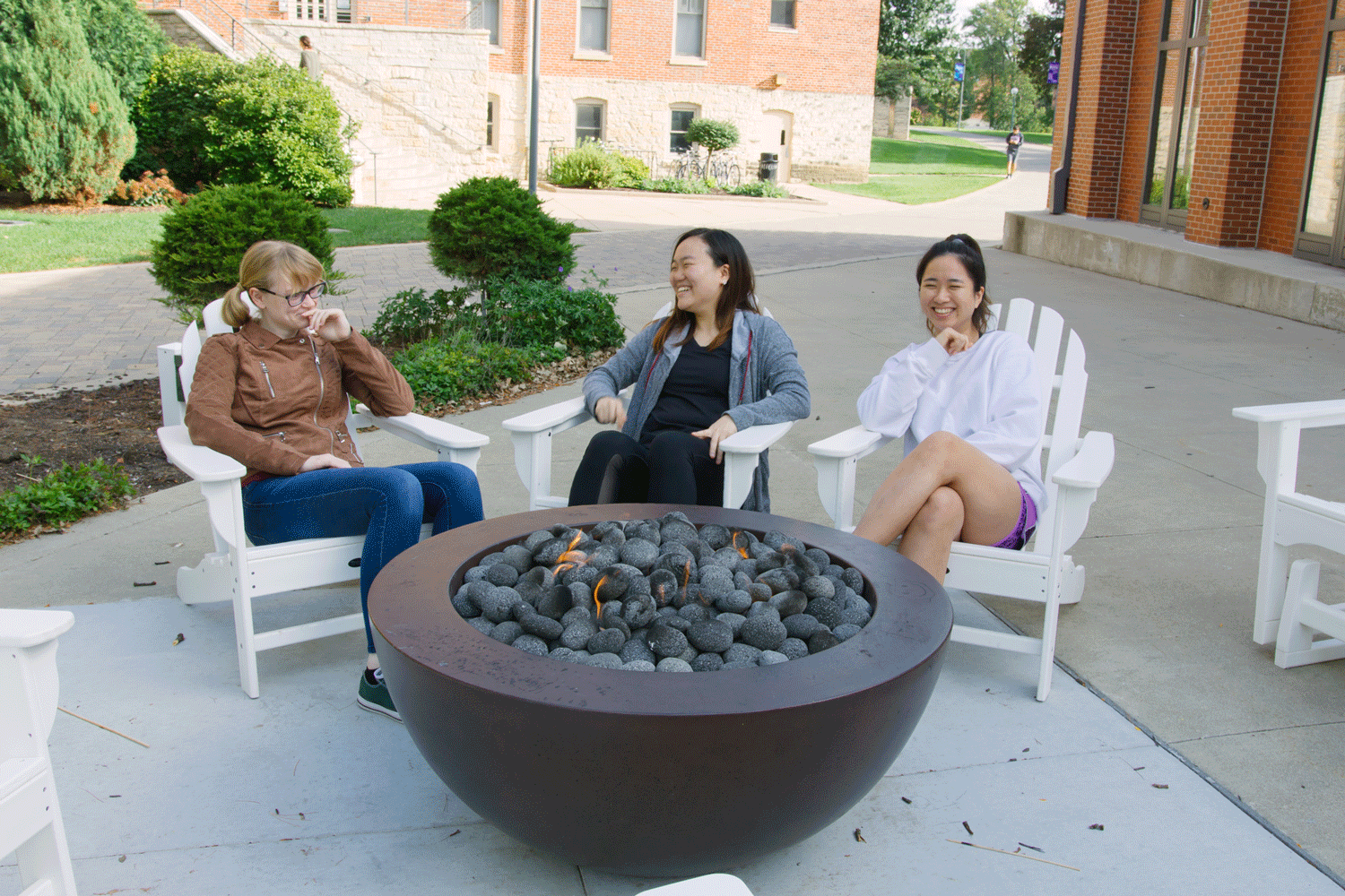 Cornell students take a break over the block break by the firepit on campus