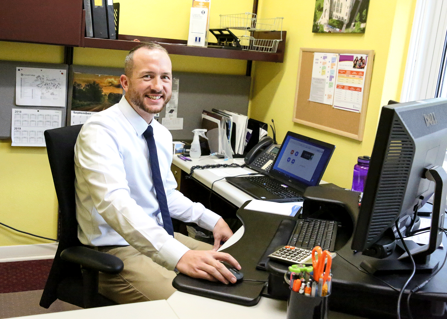Financial Aid counselor sits in the Financial Aid Office ready to help students
