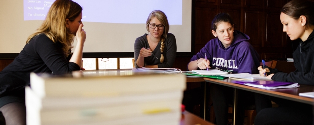 Students discuss around a table