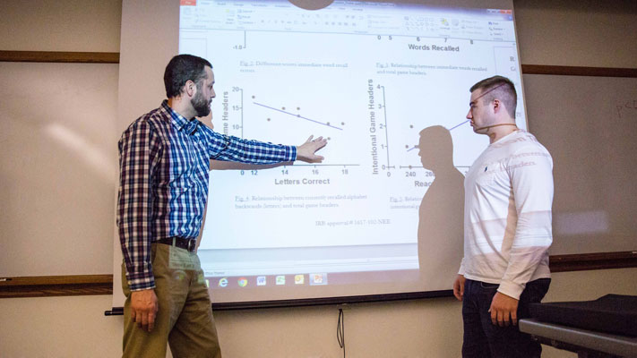 cornell college psychology professor works with a student