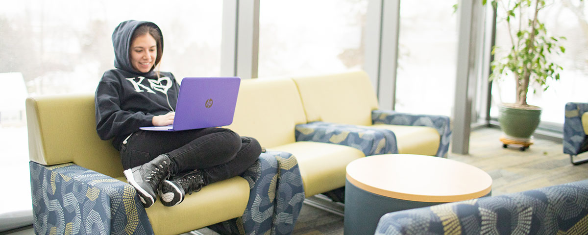 Student working on a laptop in Russell Science Center lounge