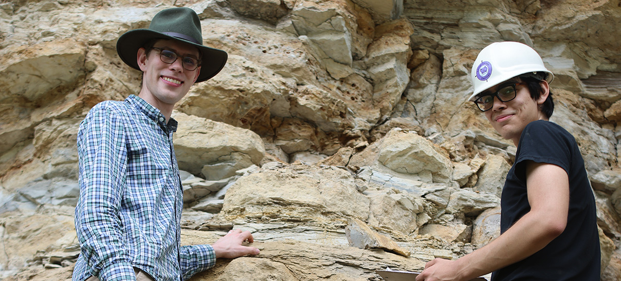 Geology professor and student gathering samples in the field.