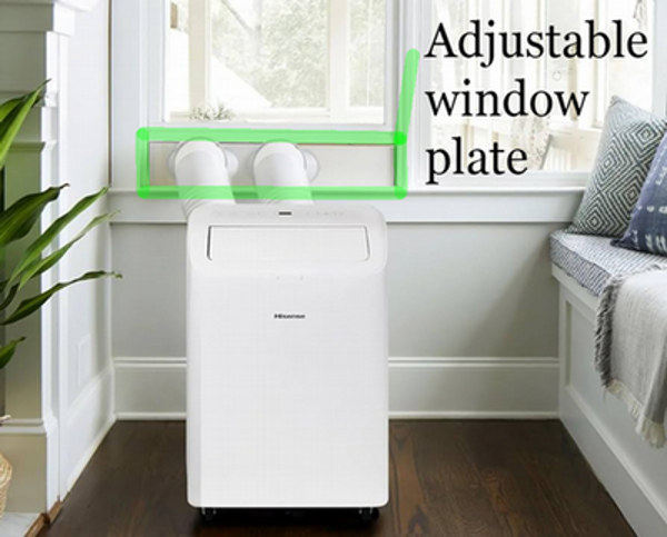An image of a portable air condition unit sitting on the floor and exhausting out the window. A green mark highlights the adjustable window plate that holds the exhaust hoses and allows a window to stay shut.