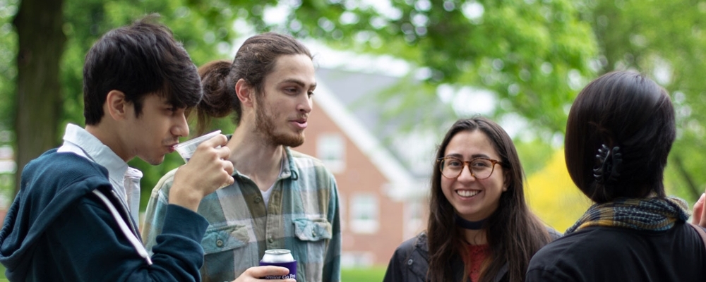 Four students hang outside on the campus at Cornell College in Mount Vernon, Iowa.