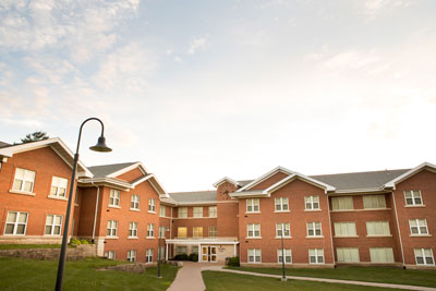 Exterior of residence hall called Russell Hall on a sunny day