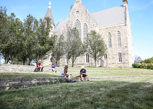 Four students study on the campus amphitheatre at Cornell College in Mount Vernon, Iowa.