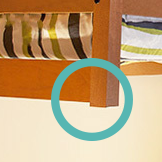 Image of our bed headboard that illustrates how little room there is for some bed risers to fit.
