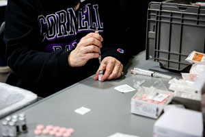 Cornell College nurse works on giving a vaccine to a student